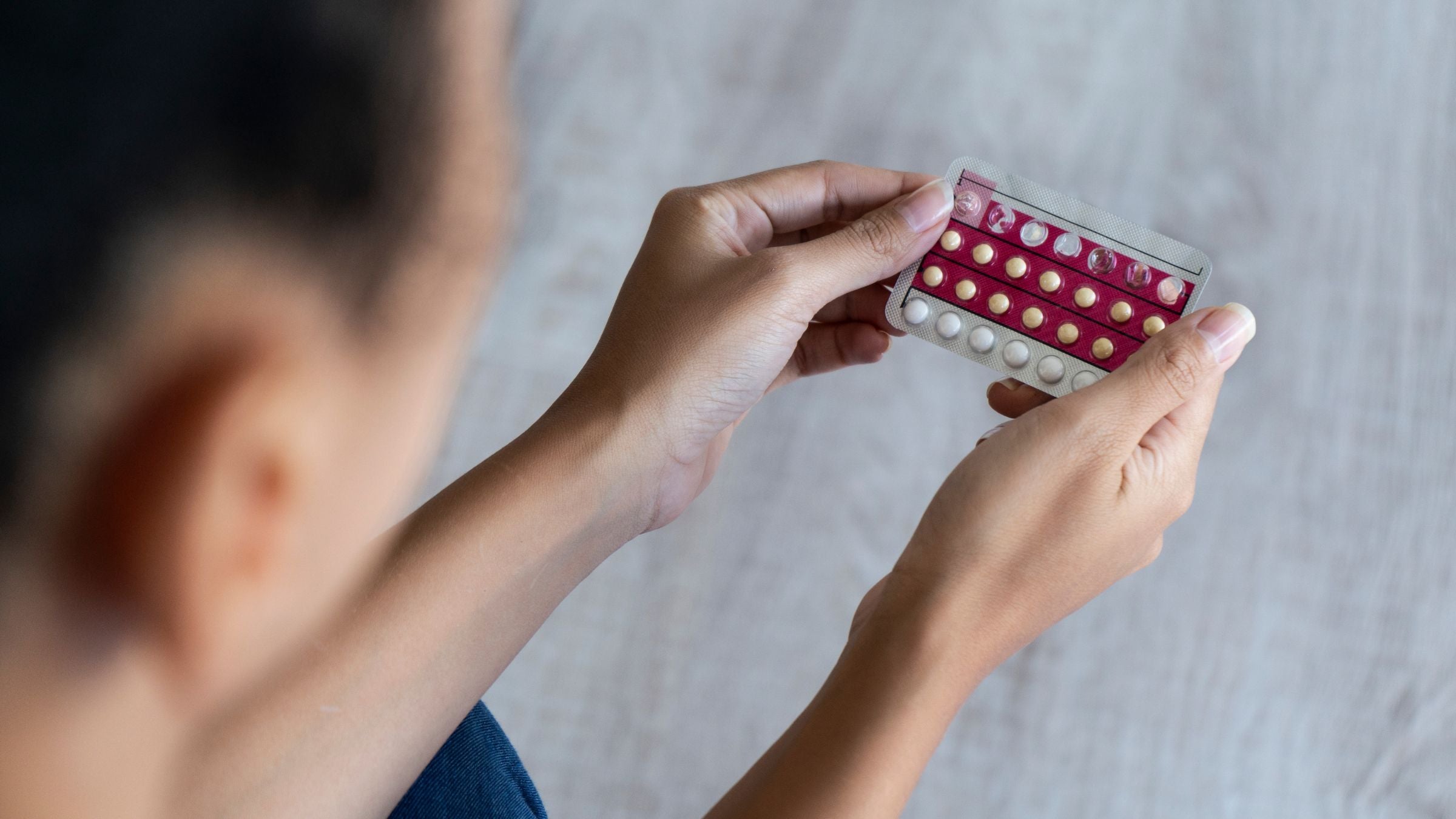 A woman looks at the birth control pill and asks "Should athletes take hormonal birth control?"