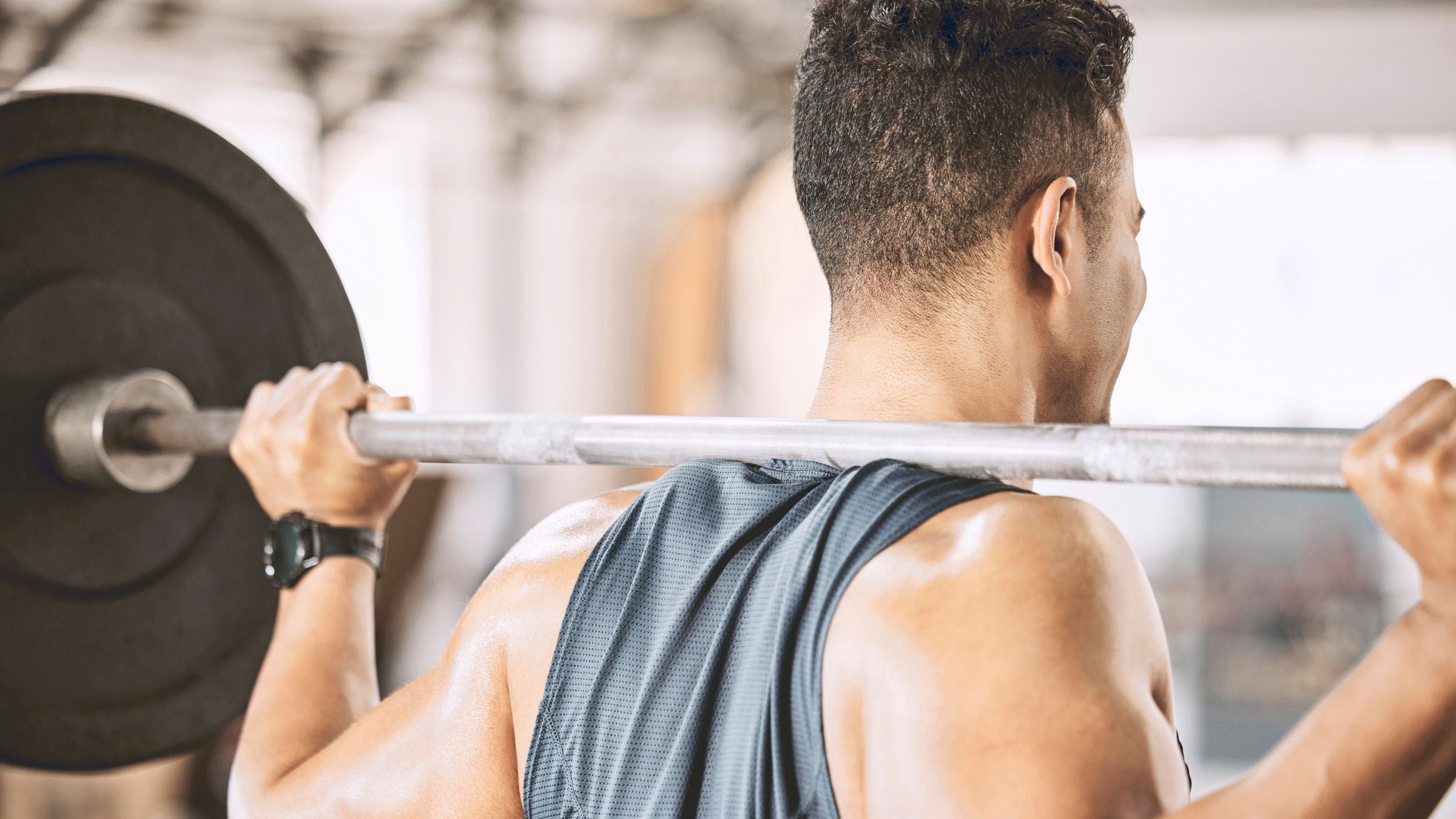 A man is lifting weights in a gym