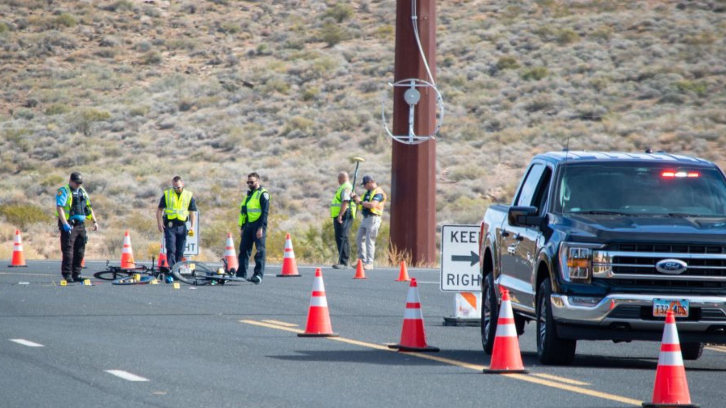 Police investigate a crash during Ironman 70.3 World Championships in St. George