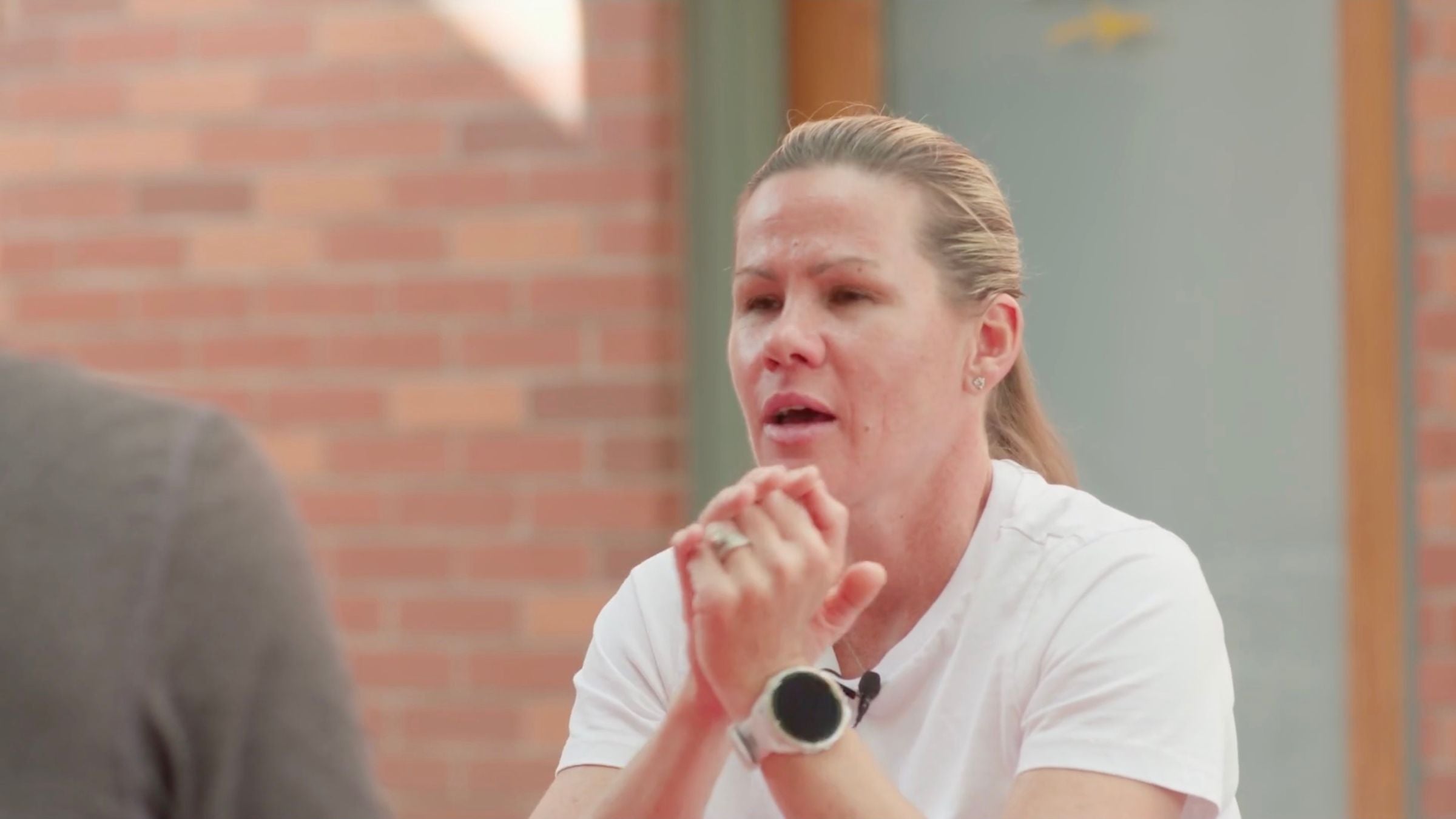 Mirinda Carfrae in a ponytail and white tshirt talks 70.3 Chattanooga 2023 Preview