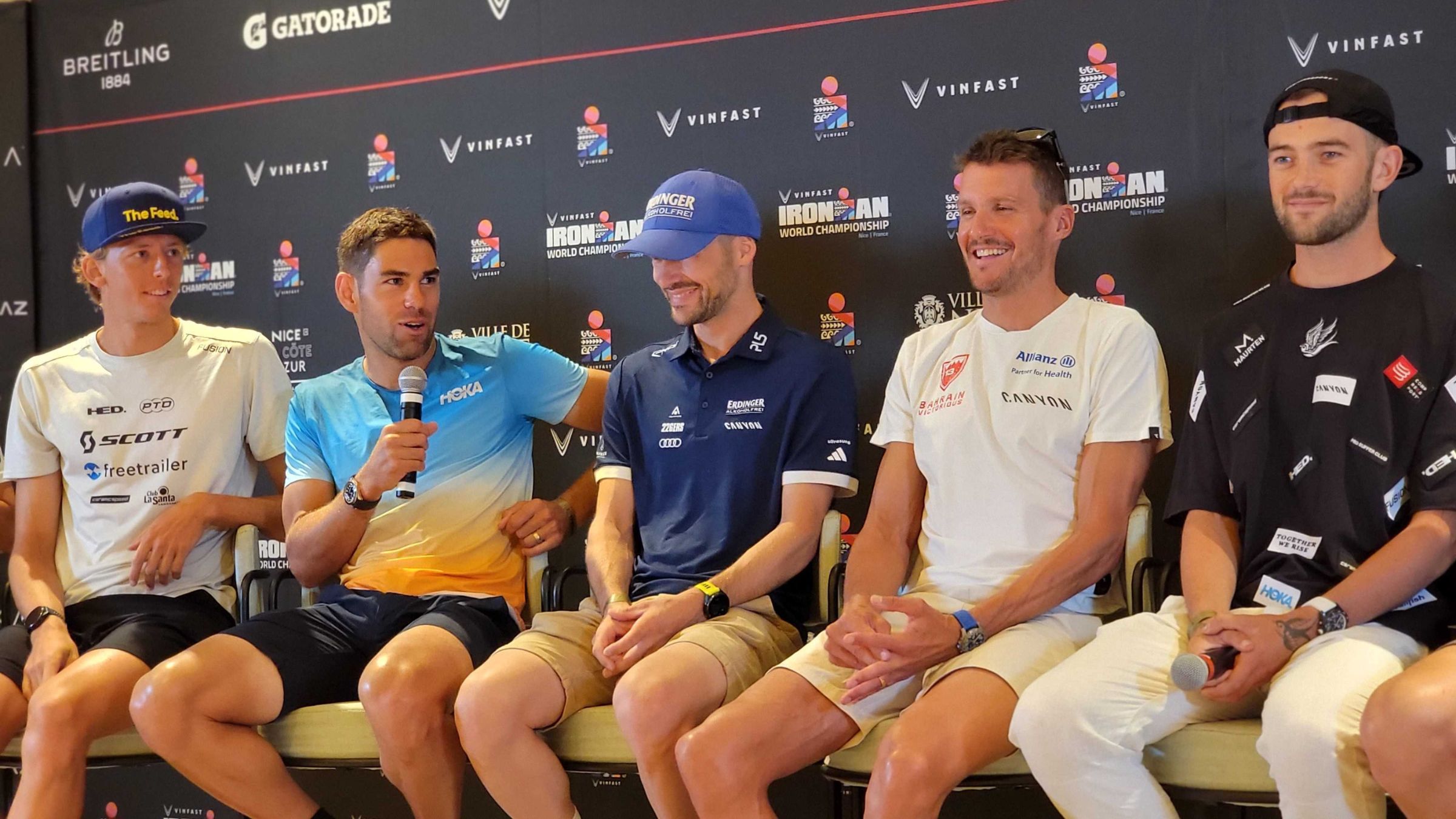 Joe Skipper (second from right) speaks at the 2023 men's Ironman World Championship pre-race press conference, flanked by Magnus Ditlev (L), Patrick Lange, Jan Frodeno, and Sam Laidlow.